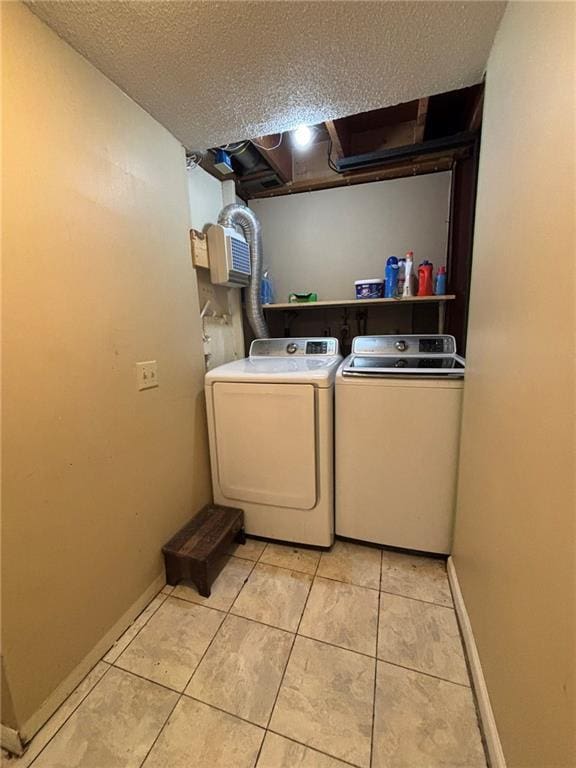2425 Elephant Trl, Saint Joseph, MO 64506 - laundry area with washing machine and clothes dryer, light tile patterned floors, and a textured ceiling