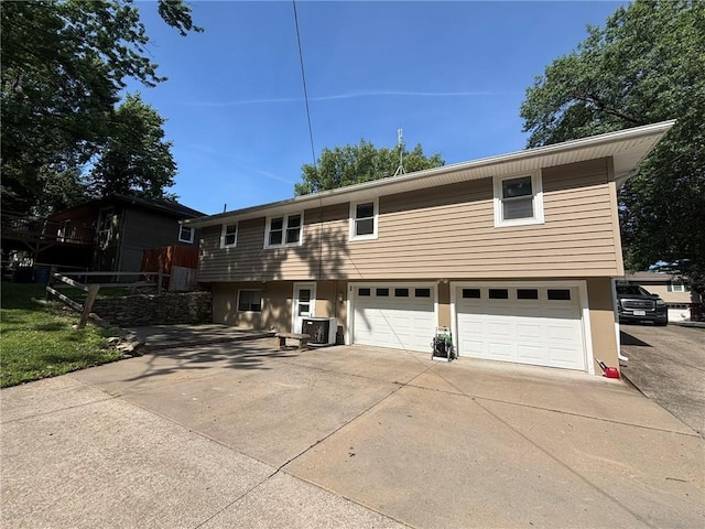2425 Elephant Trl, Saint Joseph, MO 64506 - view of front of house with driveway, a garage, and stucco siding