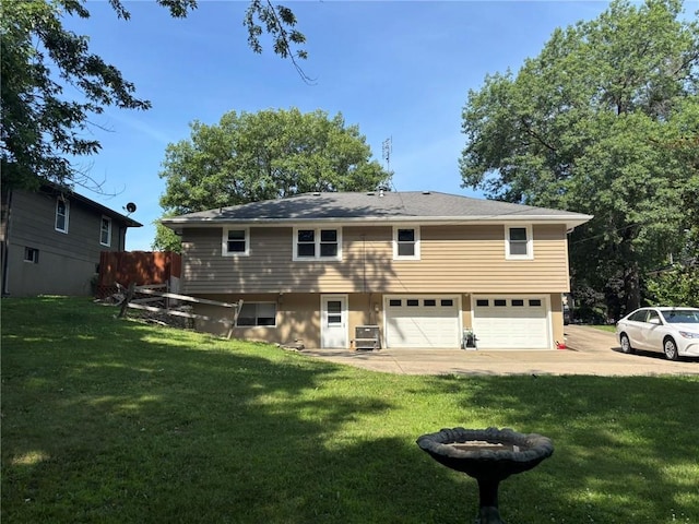 2425 Elephant Trl, Saint Joseph, MO 64506 - back of property with a lawn, an attached garage, and driveway