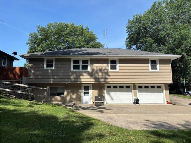 2425 Elephant Trl, Saint Joseph, MO 64506 - rear view of property with driveway, a garage, and a lawn
