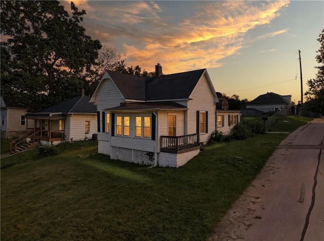 216 Dunbar Ave, Excelsior Springs, MO 64024 - back of property with a chimney, a yard, and a shingled roof