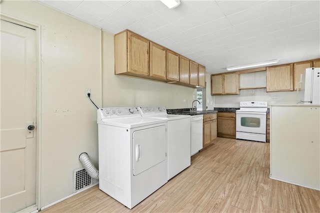 216 Dunbar Ave, Excelsior Springs, MO 64024 - washroom featuring separate washer and dryer and light wood-style floors