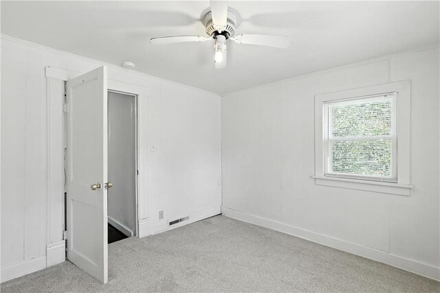 216 Dunbar Ave, Excelsior Springs, MO 64024 - unfurnished bedroom featuring carpet floors, crown molding, and a ceiling fan