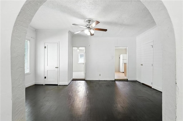 216 Dunbar Ave, Excelsior Springs, MO 64024 - unfurnished room featuring ceiling fan, a textured ceiling, dark wood-style flooring, healthy amount of natural light, and crown molding