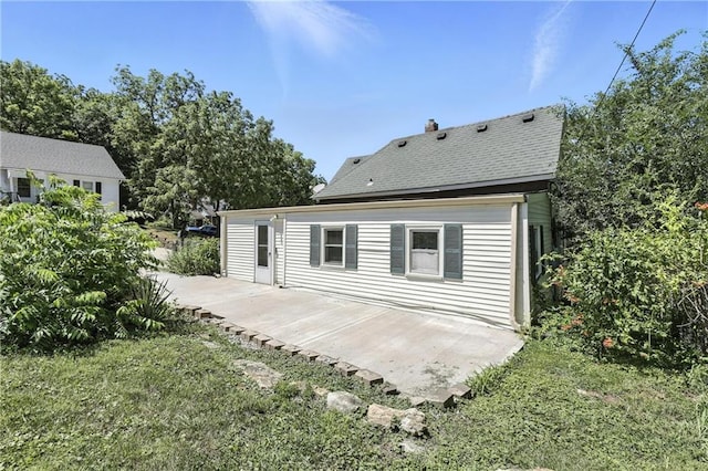 216 Dunbar Ave, Excelsior Springs, MO 64024 - rear view of property featuring a patio and a yard