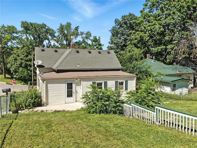 216 Dunbar Ave, Excelsior Springs, MO 64024 - back of house with a patio area, a chimney, and a shingled roof