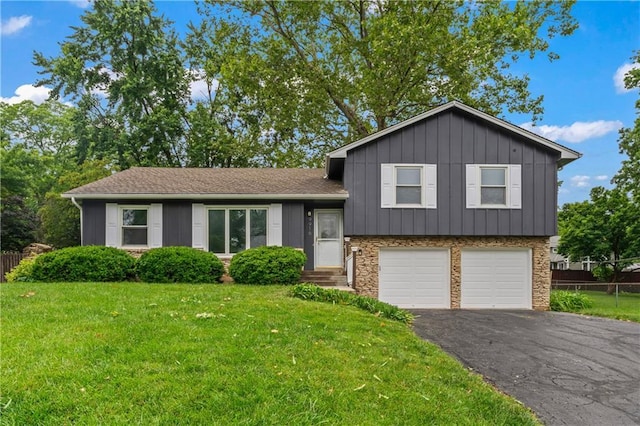 9916 Floyd St, Overland Park, KS 66212 - split level home with an attached garage, asphalt driveway, and board and batten siding