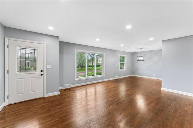 9916 Floyd St, Overland Park, KS 66212 - unfurnished living room with recessed lighting, wood finished floors, and a chandelier