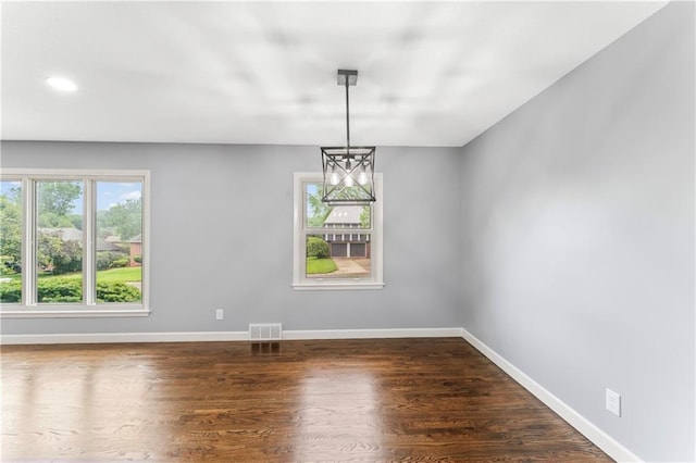 9916 Floyd St, Overland Park, KS 66212 - spare room featuring recessed lighting, dark wood-type flooring, and a chandelier