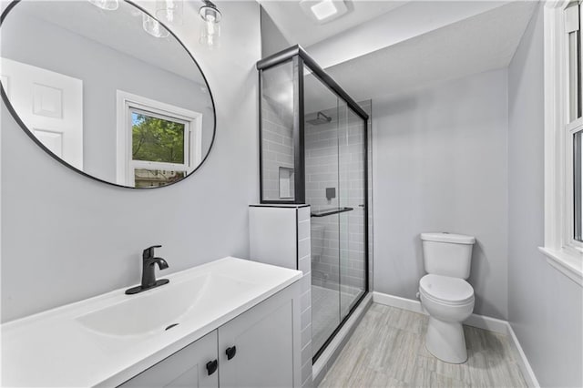 9916 Floyd St, Overland Park, KS 66212 - bathroom featuring vanity, a stall shower, and wood finished floors
