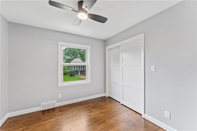 9916 Floyd St, Overland Park, KS 66212 - unfurnished bedroom with wood finished floors, a closet, and ceiling fan