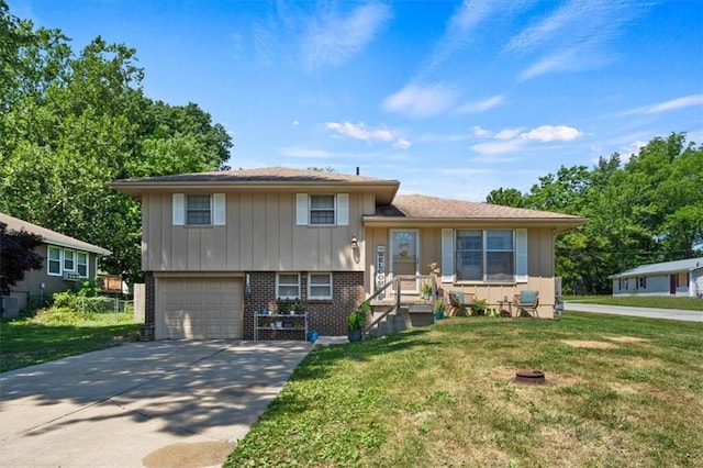 800 S Park Ave, Oak Grove, MO 64075 - split level home featuring brick siding, a garage, concrete driveway, and a front lawn
