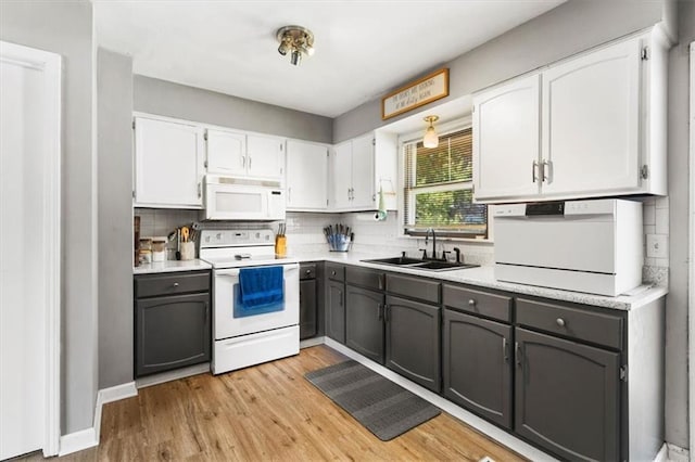 800 S Park Ave, Oak Grove, MO 64075 - kitchen with white appliances, white cabinetry, tasteful backsplash, light wood finished floors, and gray cabinetry