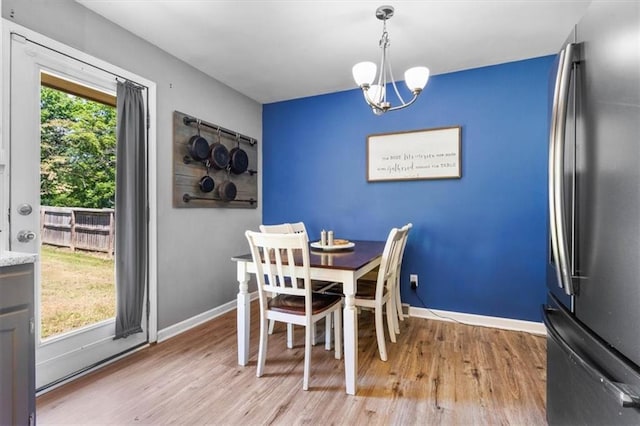 800 S Park Ave, Oak Grove, MO 64075 - dining area with light wood finished floors and a chandelier