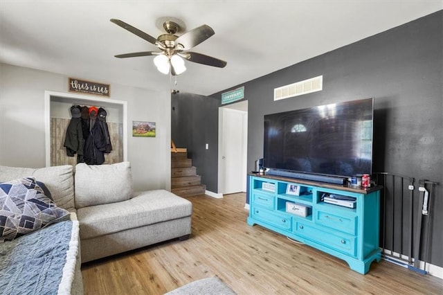 800 S Park Ave, Oak Grove, MO 64075 - living room featuring light wood finished floors, ceiling fan, and stairway