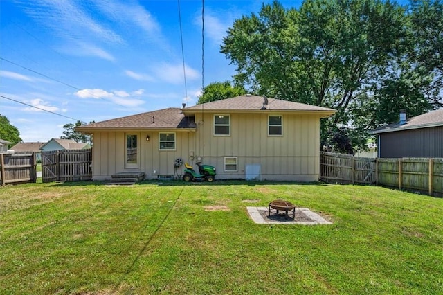 800 S Park Ave, Oak Grove, MO 64075 - back of property featuring board and batten siding, an outdoor fire pit, and a fenced backyard