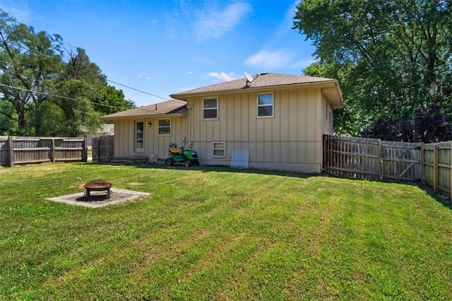 800 S Park Ave, Oak Grove, MO 64075 - back of house featuring a fire pit, board and batten siding, and a fenced backyard