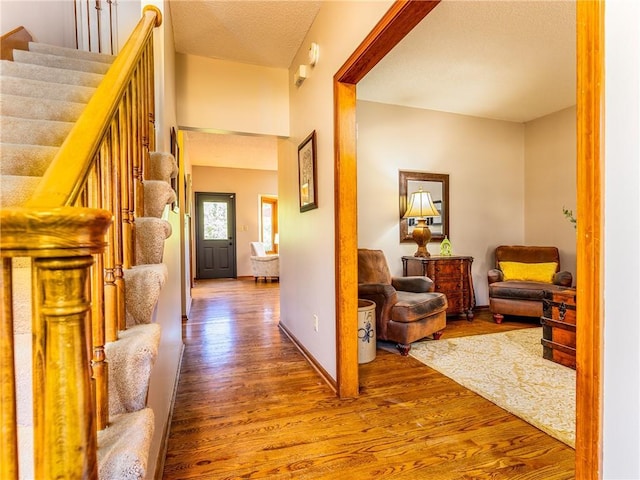 28804 E 116th St, Lees Summit, MO 64086 - corridor featuring wood finished floors, stairs, and a textured ceiling