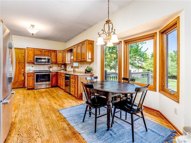 28804 E 116th St, Lees Summit, MO 64086 - dining room with light wood finished floors and a chandelier
