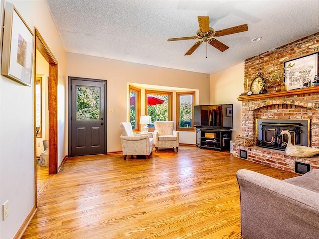 28804 E 116th St, Lees Summit, MO 64086 - living room featuring light wood finished floors, a textured ceiling, and a ceiling fan