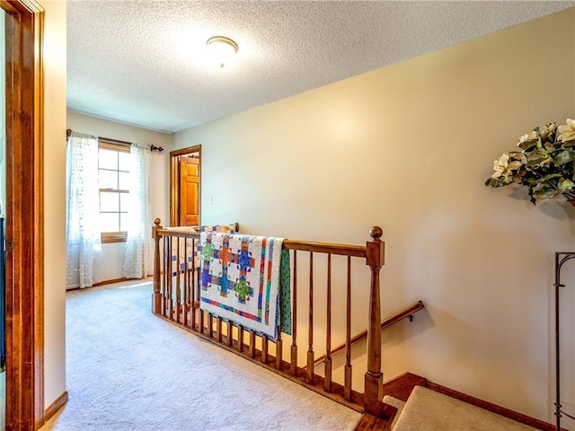 28804 E 116th St, Lees Summit, MO 64086 - hallway featuring an upstairs landing, a textured ceiling, and carpet floors