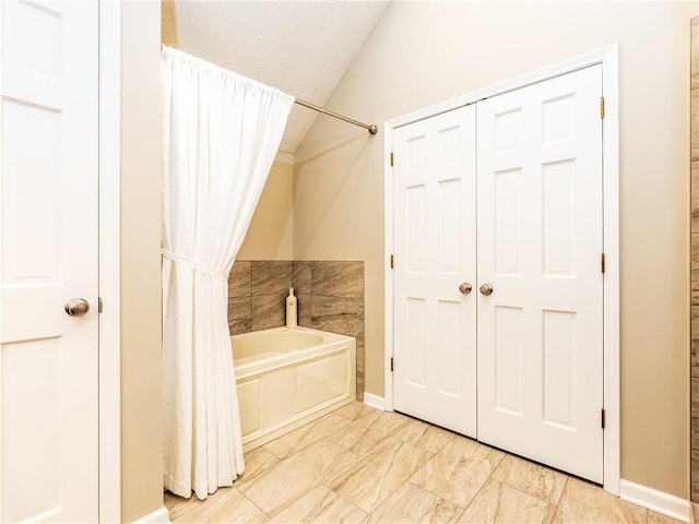 28804 E 116th St, Lees Summit, MO 64086 - full bathroom featuring marble look tile flooring and vaulted ceiling