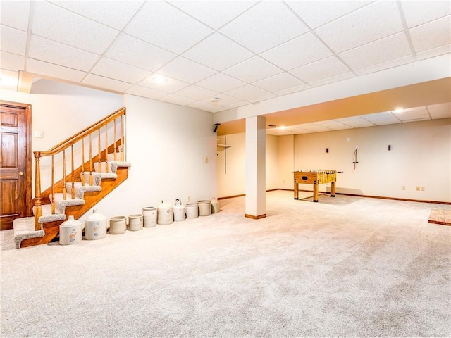 28804 E 116th St, Lees Summit, MO 64086 - finished below grade area featuring a paneled ceiling, carpet flooring, and stairs