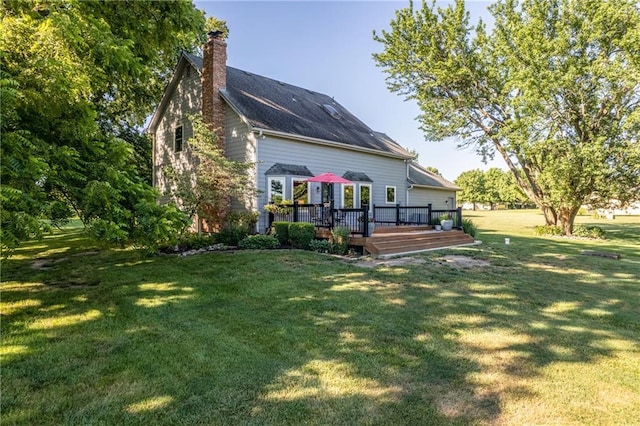 28804 E 116th St, Lees Summit, MO 64086 - rear view of house with a wooden deck, a chimney, and a yard