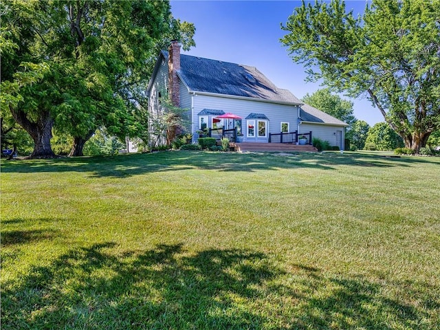 28804 E 116th St, Lees Summit, MO 64086 - back of property with a deck, a chimney, and a yard
