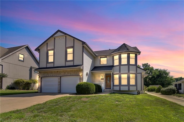 2431 S Ponca Ave, Independence, MO 64057 - view of front facade with concrete driveway, a garage, a front lawn, and stone siding