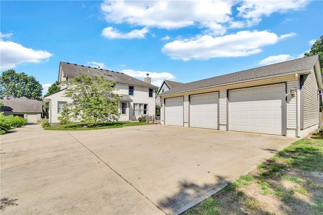 2431 S Ponca Ave, Independence, MO 64057 - view of front facade with a garage and an outbuilding