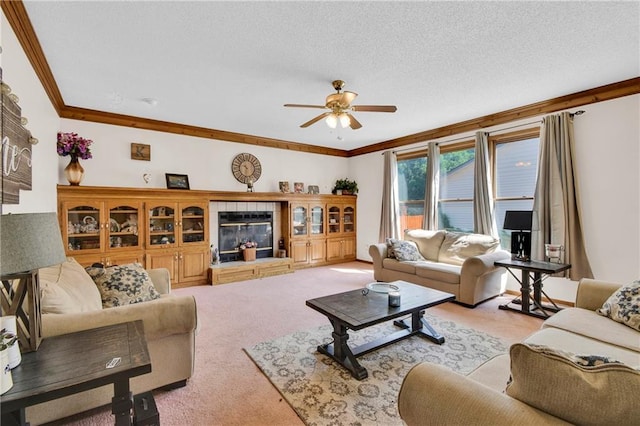 2431 S Ponca Ave, Independence, MO 64057 - living area with ornamental molding, light colored carpet, a ceiling fan, a tiled fireplace, and a textured ceiling
