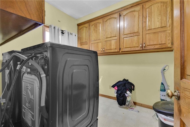 2431 S Ponca Ave, Independence, MO 64057 - laundry area with tile patterned floors, cabinet space, and washer / clothes dryer