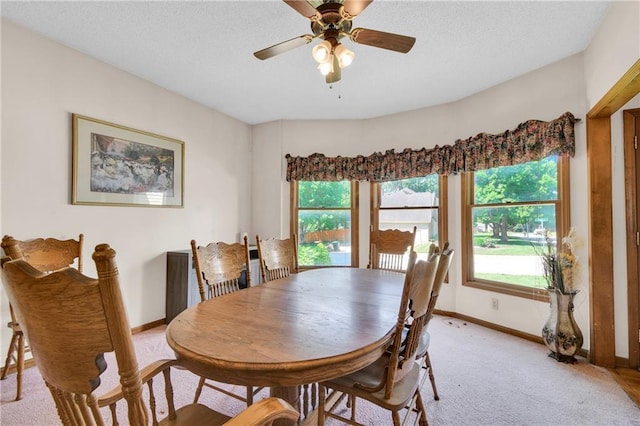 2431 S Ponca Ave, Independence, MO 64057 - dining space with light carpet, a textured ceiling, and a ceiling fan