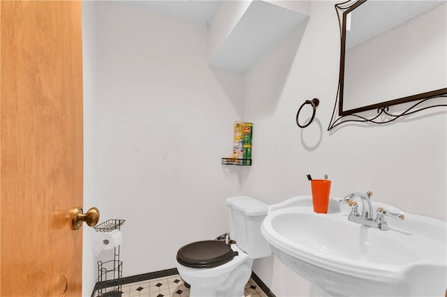 2431 S Ponca Ave, Independence, MO 64057 - half bathroom featuring toilet and tile patterned floors