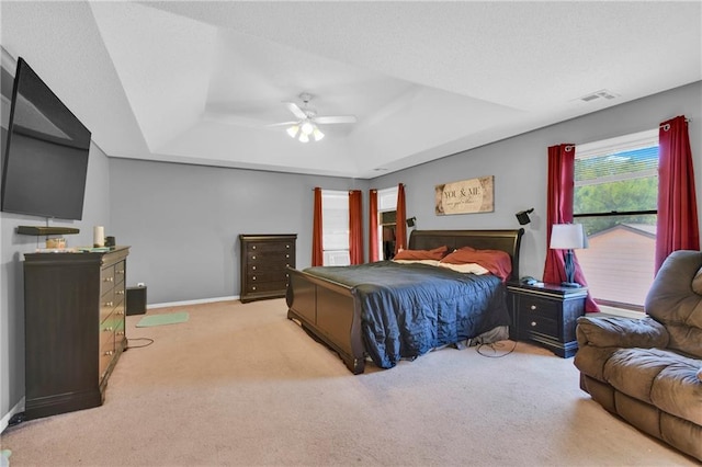 2431 S Ponca Ave, Independence, MO 64057 - bedroom with a tray ceiling, light carpet, and a ceiling fan