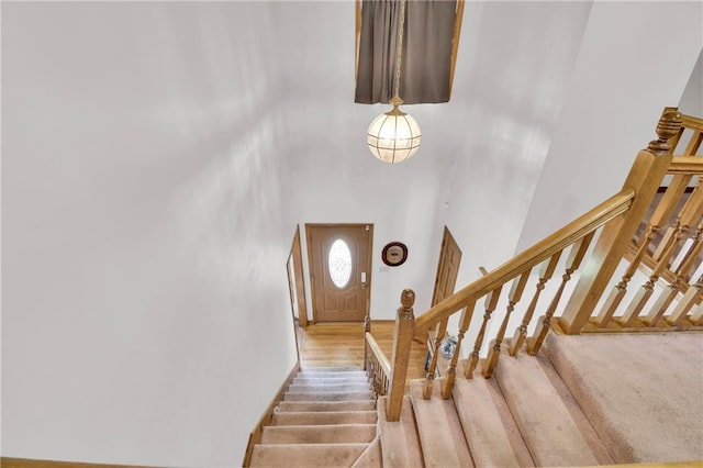 2431 S Ponca Ave, Independence, MO 64057 - staircase featuring a high ceiling and wood finished floors