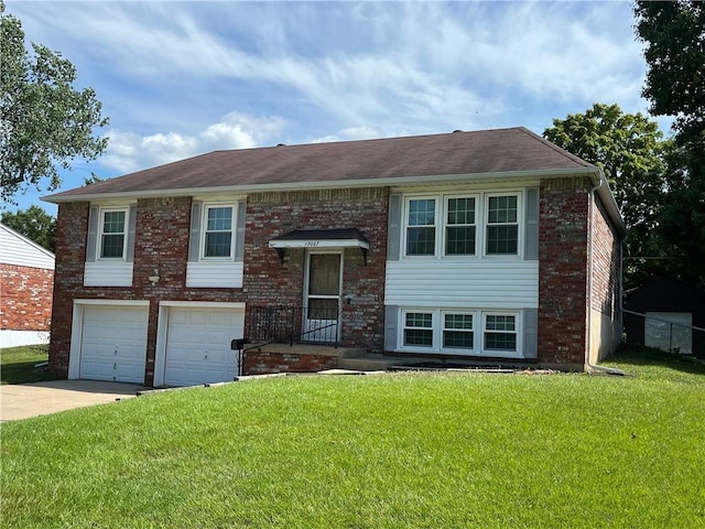 15007 E 41st St, Independence, MO 64055 - raised ranch with concrete driveway, a garage, a front yard, and brick siding