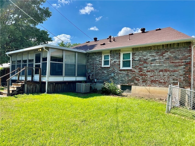 15007 E 41st St, Independence, MO 64055 - back of property with a sunroom, brick siding, and a yard