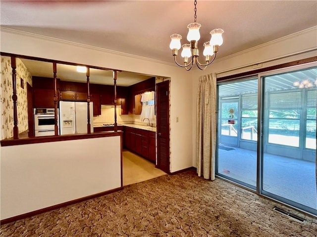 15007 E 41st St, Independence, MO 64055 - kitchen featuring white appliances, ornamental molding, a chandelier, light carpet, and pendant lighting
