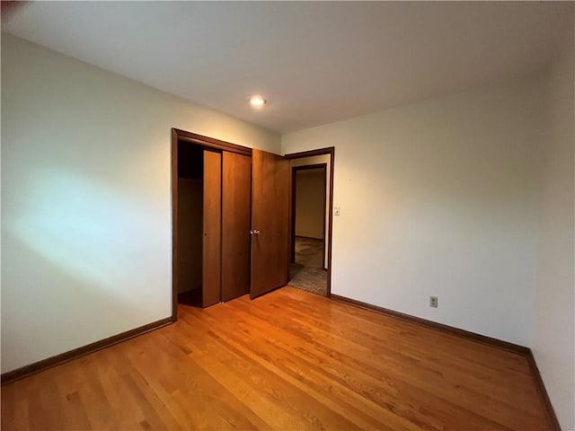 15007 E 41st St, Independence, MO 64055 - unfurnished bedroom featuring light wood-style floors, recessed lighting, and a closet
