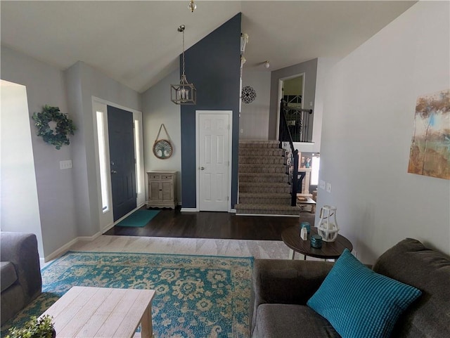 22030 W 51st Ter, Shawnee, KS 66226 - living room featuring wood finished floors, stairway, vaulted ceiling, and a chandelier