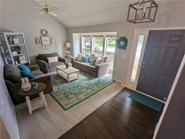 22030 W 51st Ter, Shawnee, KS 66226 - living area featuring dark wood-style floors, lofted ceiling, ceiling fan, and a chandelier
