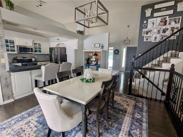 22030 W 51st Ter, Shawnee, KS 66226 - dining room featuring dark wood-style floors, stairway, a chandelier, and a high ceiling