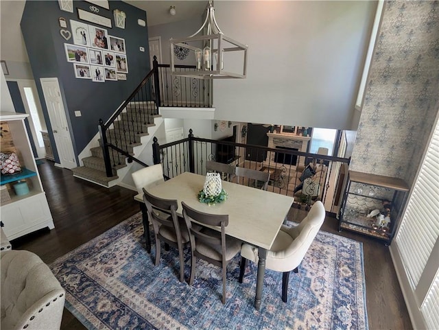 22030 W 51st Ter, Shawnee, KS 66226 - dining space featuring wood finished floors, a chandelier, and stairway