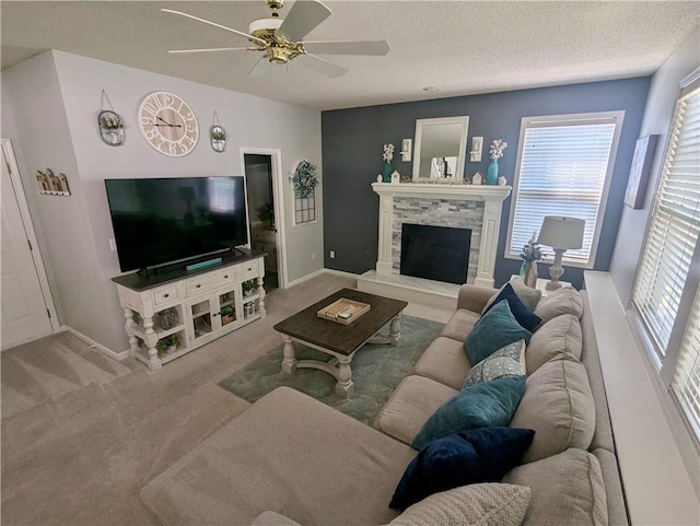 22030 W 51st Ter, Shawnee, KS 66226 - living room featuring carpet, ceiling fan, healthy amount of natural light, a textured ceiling, and a stone fireplace
