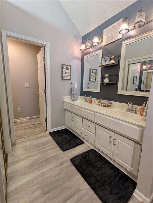 22030 W 51st Ter, Shawnee, KS 66226 - full bath featuring lofted ceiling, double vanity, and wood finished floors