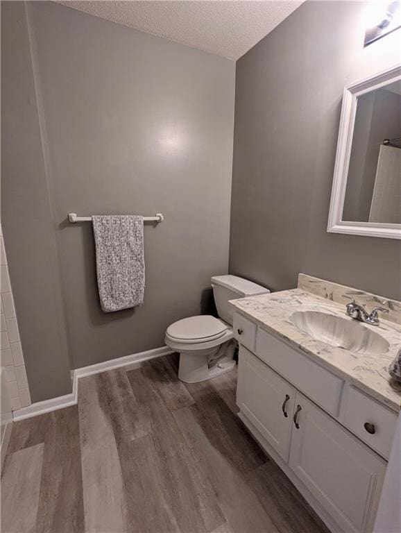 22030 W 51st Ter, Shawnee, KS 66226 - full bath with a textured ceiling, wood finished floors, vanity, and a shower with curtain
