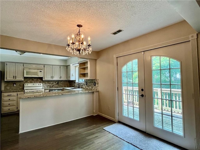 2811 Chatelain Ct Unit A, Independence, MO 64057 - kitchen featuring white appliances, dark wood-type flooring, a peninsula, backsplash, and a textured ceiling