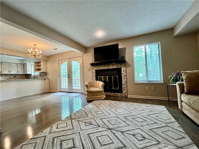 2811 Chatelain Ct Unit A, Independence, MO 64057 - living room with a textured ceiling, a high end fireplace, dark wood-style floors, healthy amount of natural light, and a chandelier